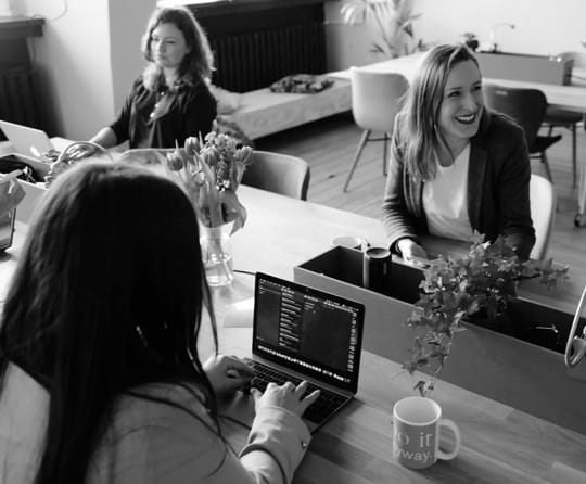 three ladies in an open office